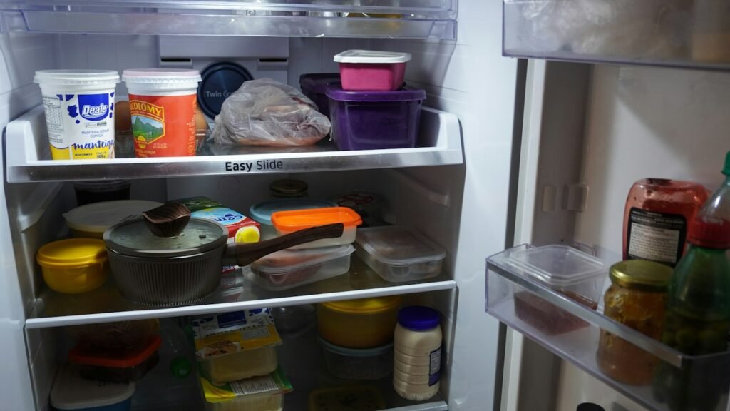 Organized refrigerator containing prepared foods and storage containers