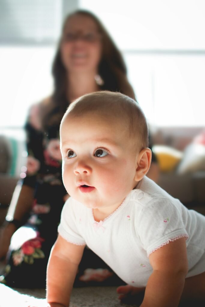 Baby crawling on the floor of a living room, at the eye level where hazards are easiest to spot