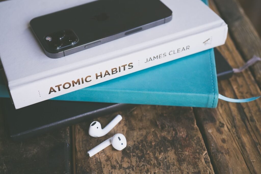 Phone set down on top of books on a table during a digital detox