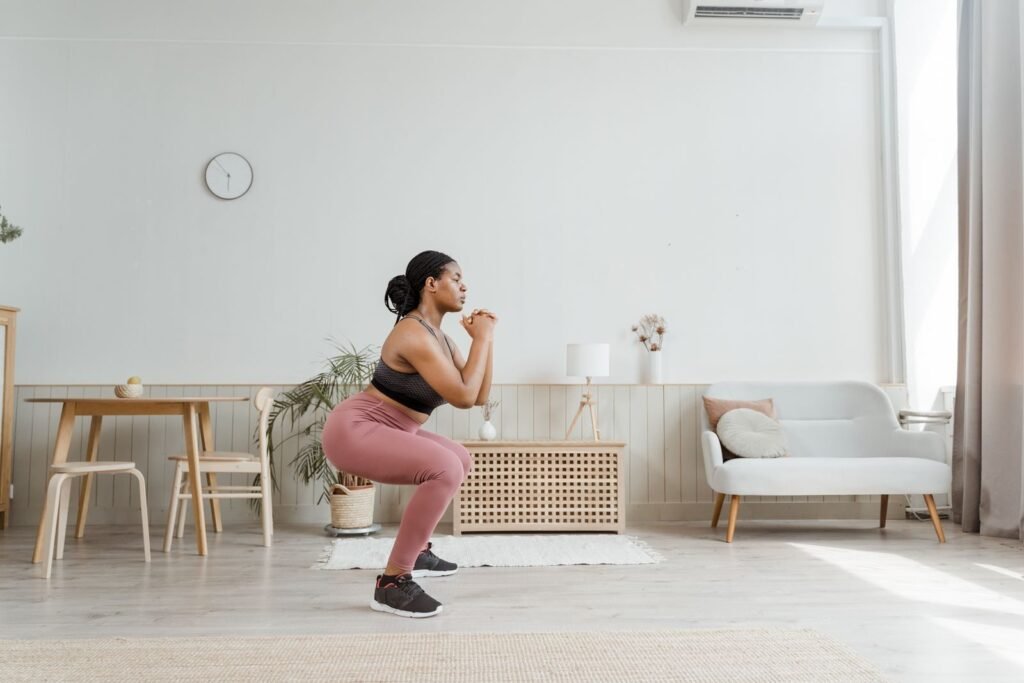 Woman doing a quick bodyweight squat at home as a short exercise snack