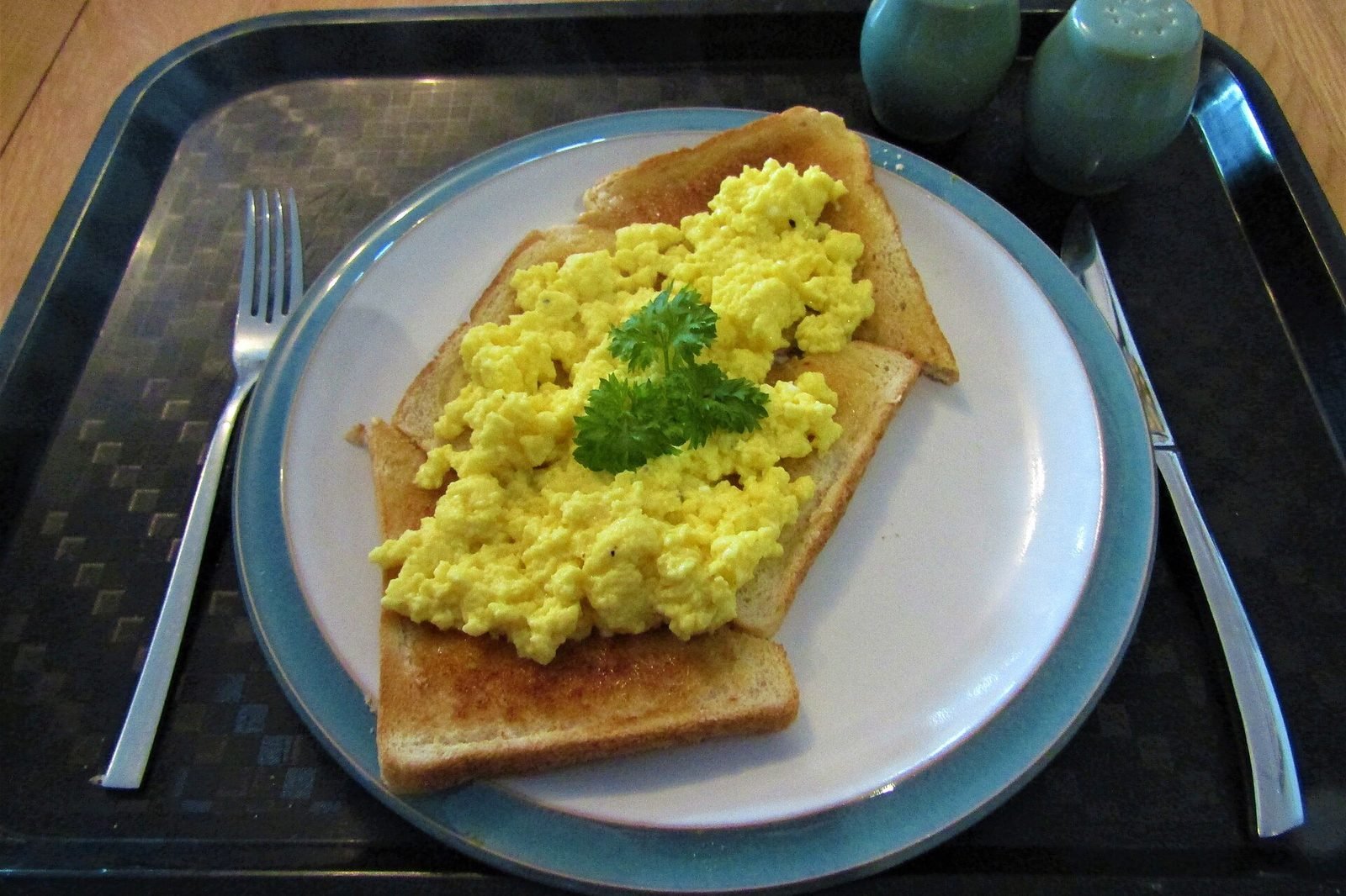 Scrambled eggs on toast served on a plate