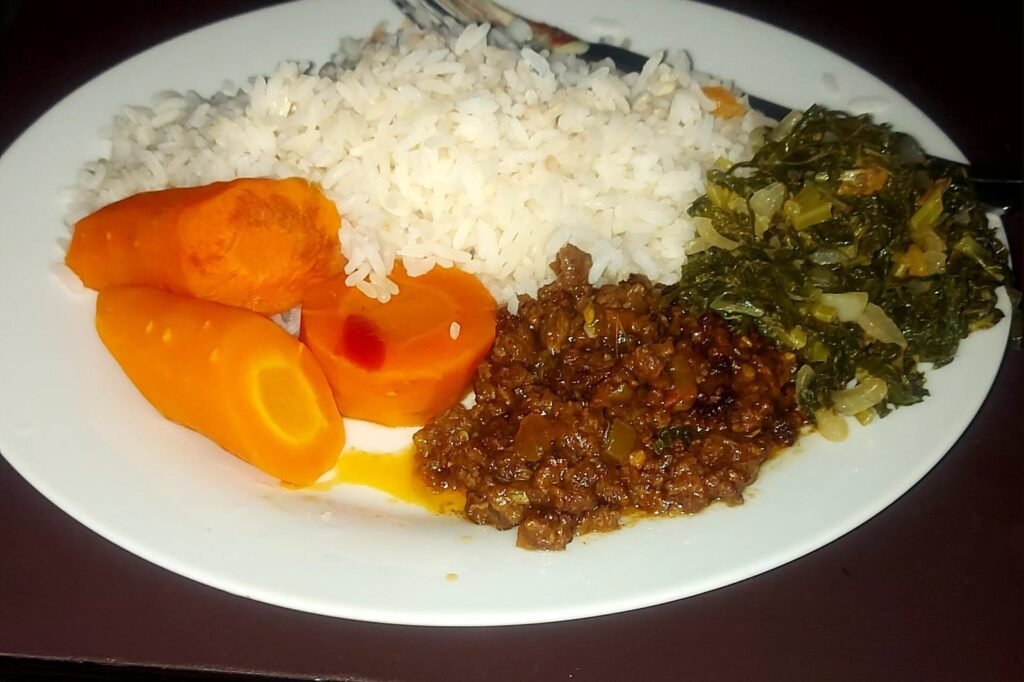 Plate with rice, carrots, greens, and a protein portion