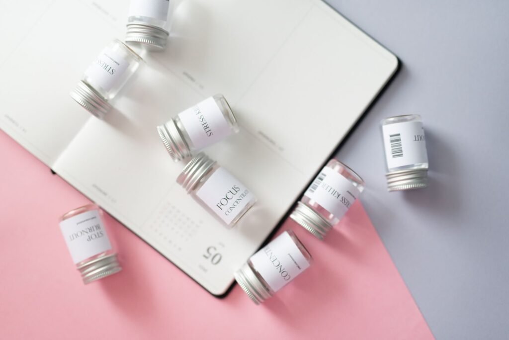 Open notebook beside medicine bottles for keeping an up-to-date medication list